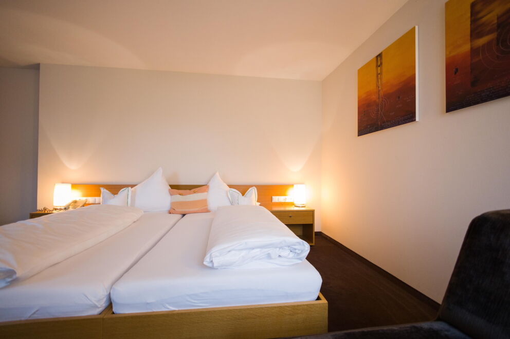 Modern, inviting double room with soft cushions and stylish lighting.