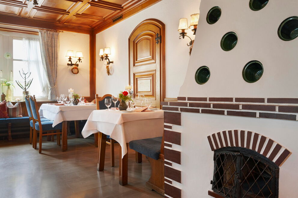 Elegant restaurant with wooden furniture and lovingly laid tables.