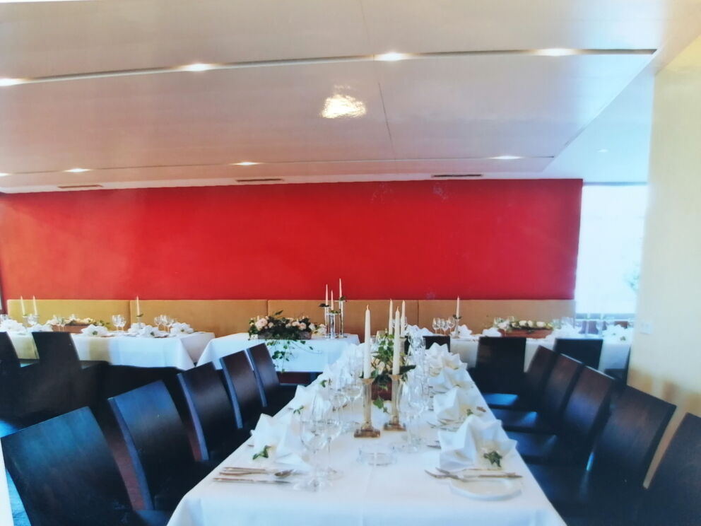 Stylishly laid tables with candles and floral decorations in an elegant room.