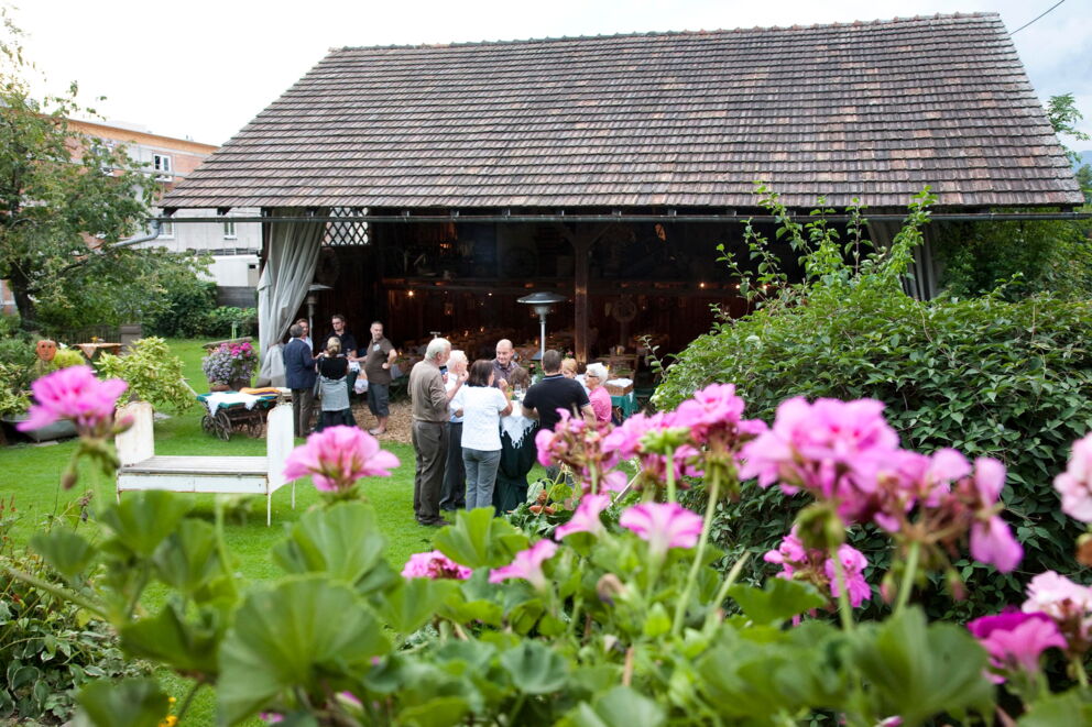 People gather in a blooming garden for a social get-together.