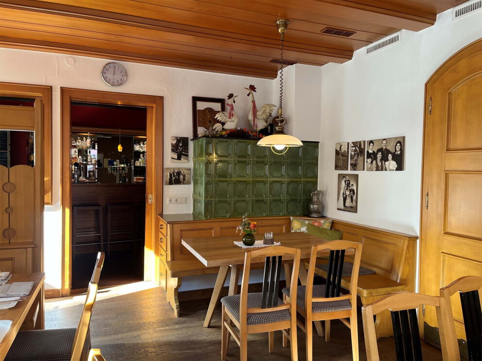 Cozy inn with wooden furniture and historical photographs on the wall.
